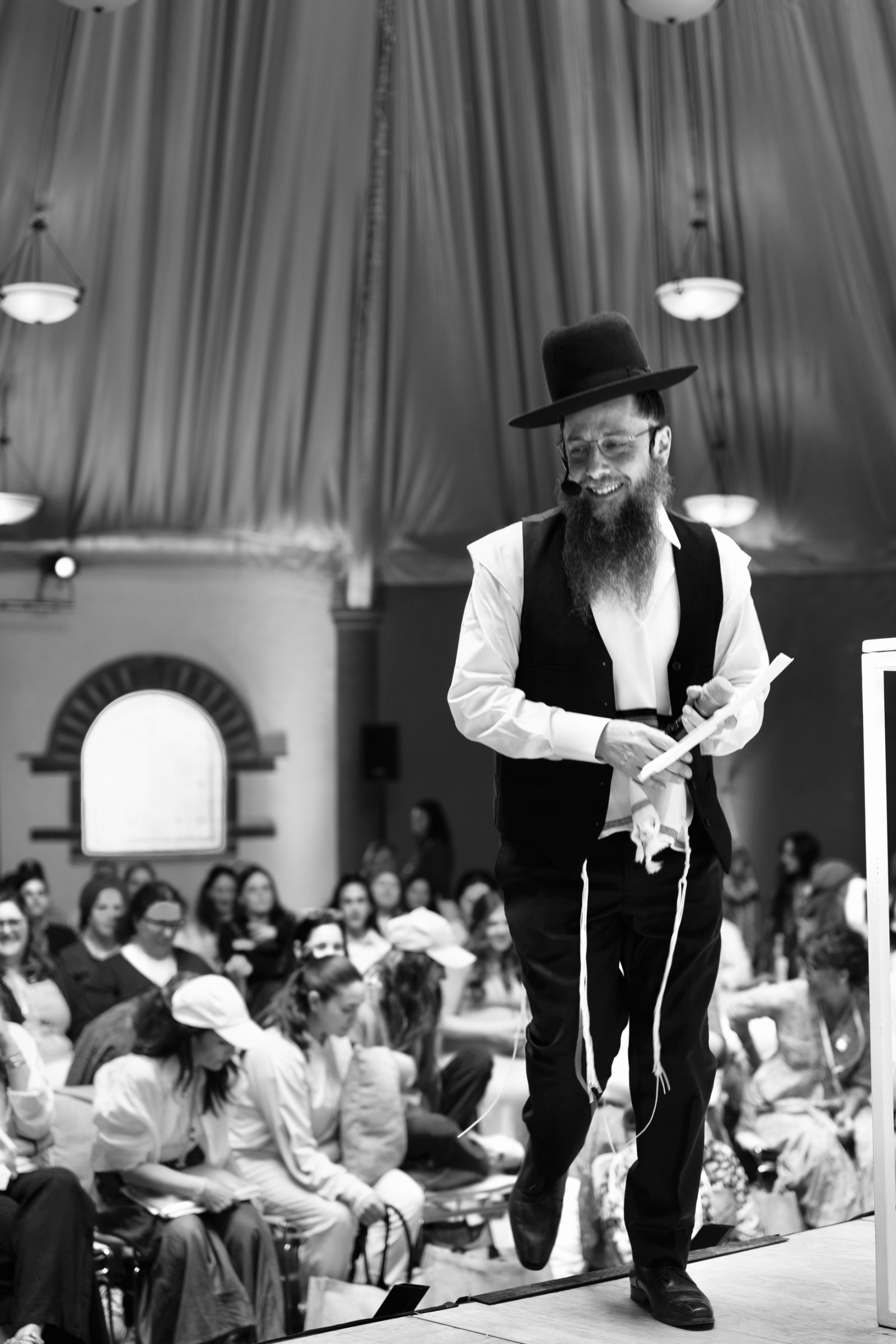 Rav Doniel teaching on stage