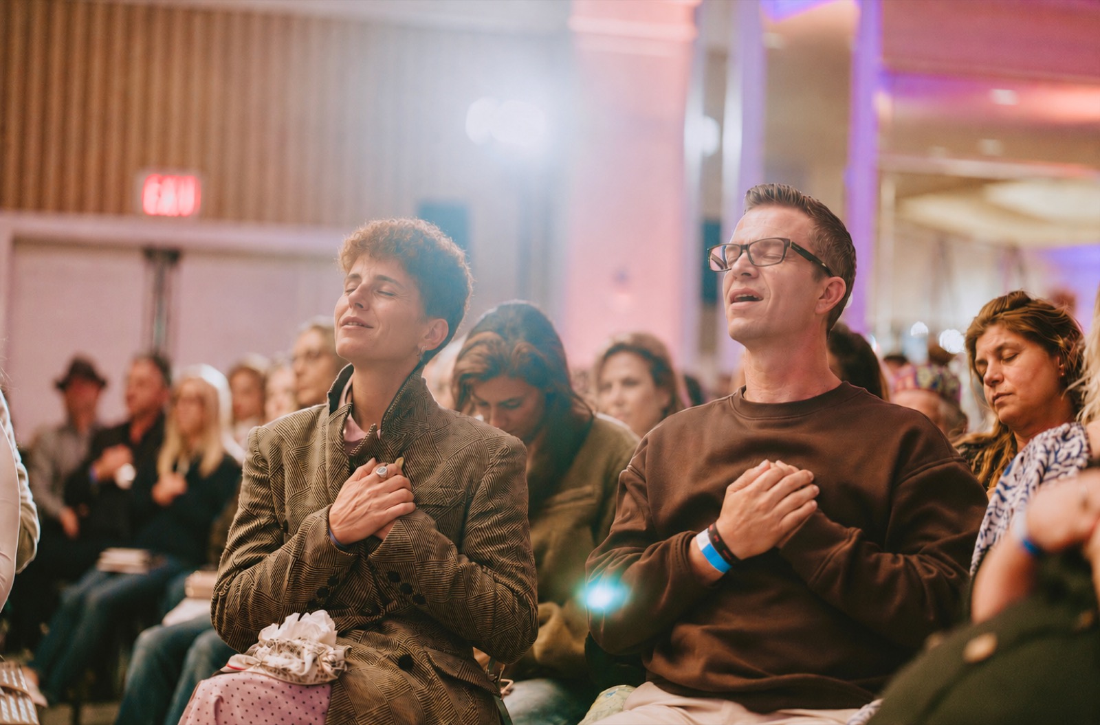 Students in prayer at an Elevation gathering